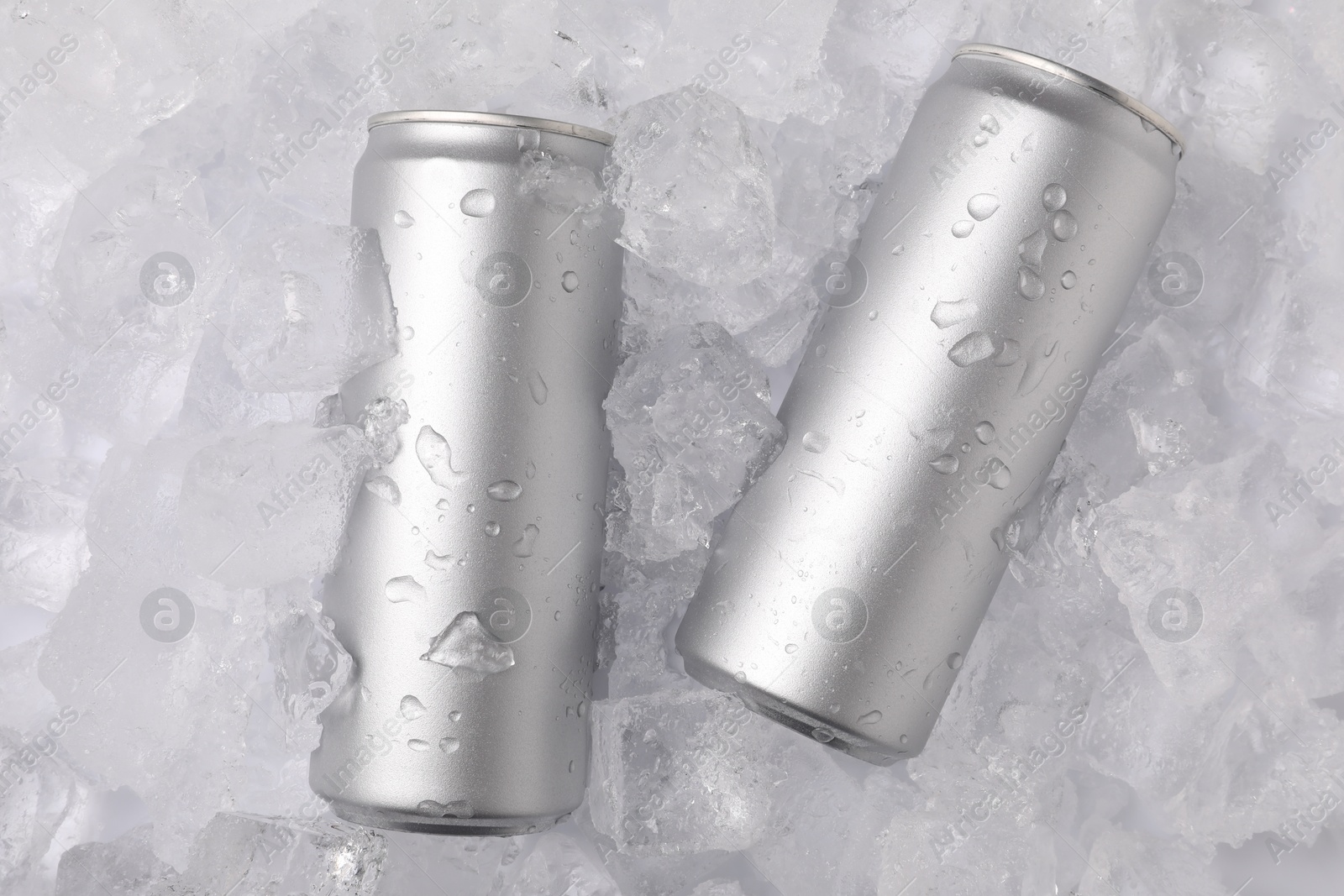Refreshing drinks in cans on ice cubes, top view Photo of Refreshing drinks in cans on ice cubes, top view