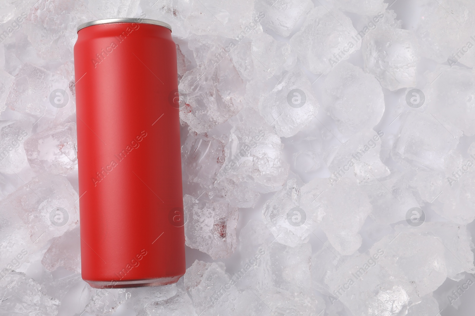 Refreshing drink in can on ice cubes, top view. Space for text Photo of Refreshing drink in can on ice cubes, top view. Space for text