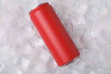 Photo of Refreshing drink in can on ice cubes, top view