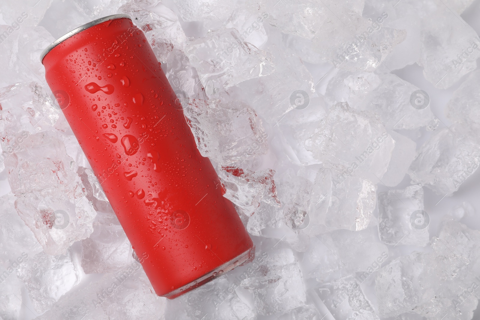 Refreshing drink in can on ice cubes, top view. Space for text Photo of Refreshing drink in can on ice cubes, top view. Space for text