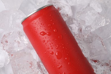 Photo of Refreshing drink in can on ice cubes, top view
