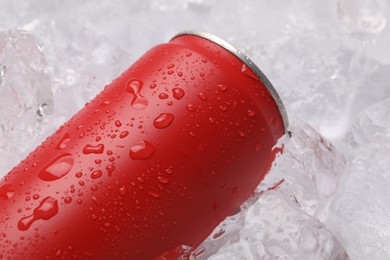Photo of Refreshing drink in can on ice cubes, closeup