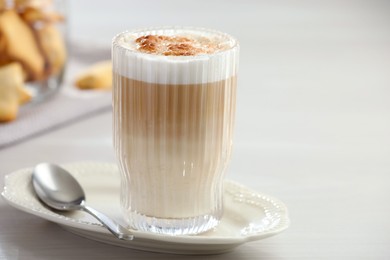 Photo of Tasty latte macchiato in glass on white table, space for text. Coffee drink