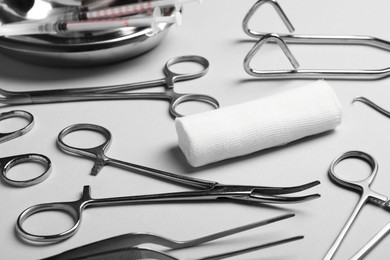 Different surgical instruments on light grey background, closeup