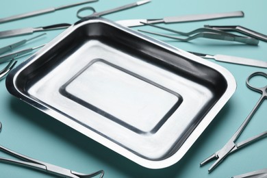 Different surgical tools on turquoise background, closeup