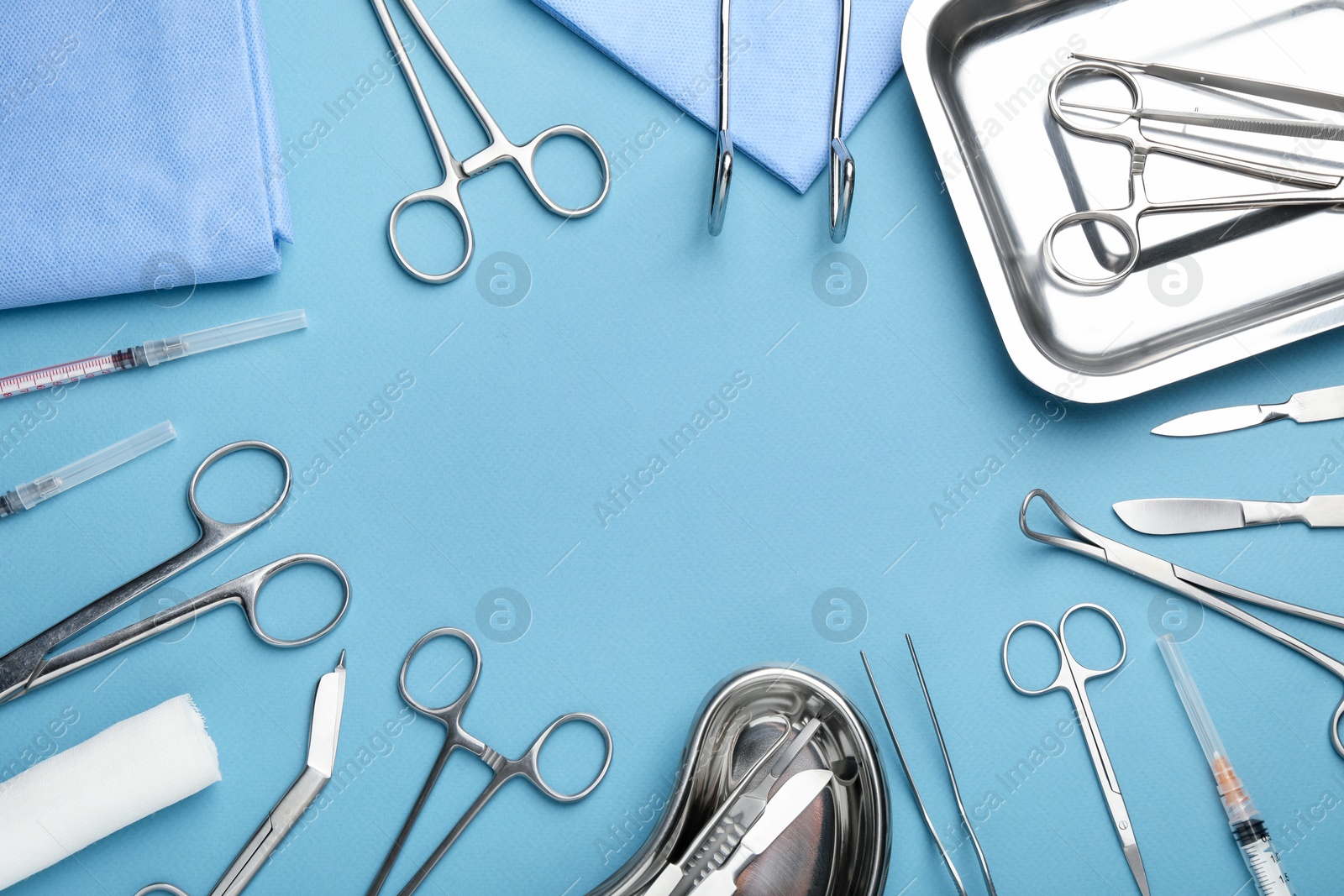 Photo of Different surgical tools on light blue background, flat lay. Space for text