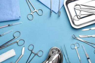 Photo of Different surgical tools on light blue background, flat lay. Space for text