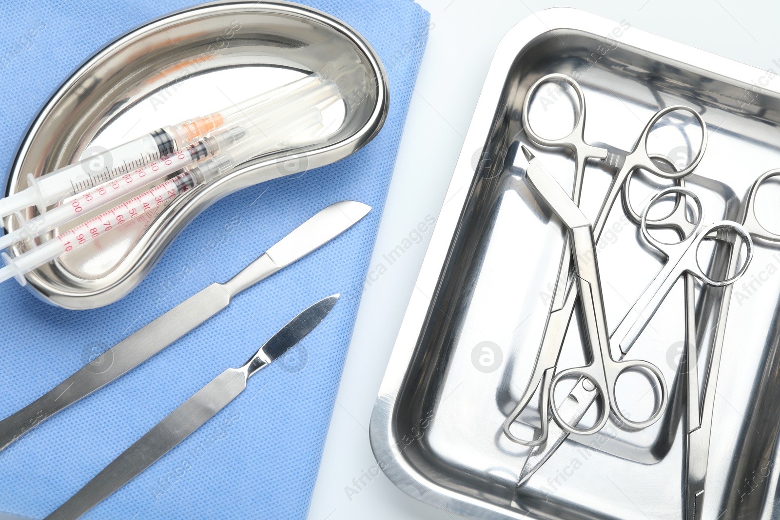 Photo of Different surgical tools on light gray background, flat lay