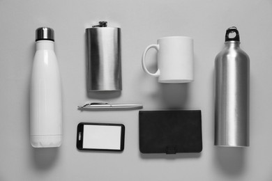 Photo of Different blank items for branding on gray background, flat lay. Mockup for design