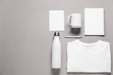 Photo of Different blank items for branding on grey background, flat lay. Mockup for design