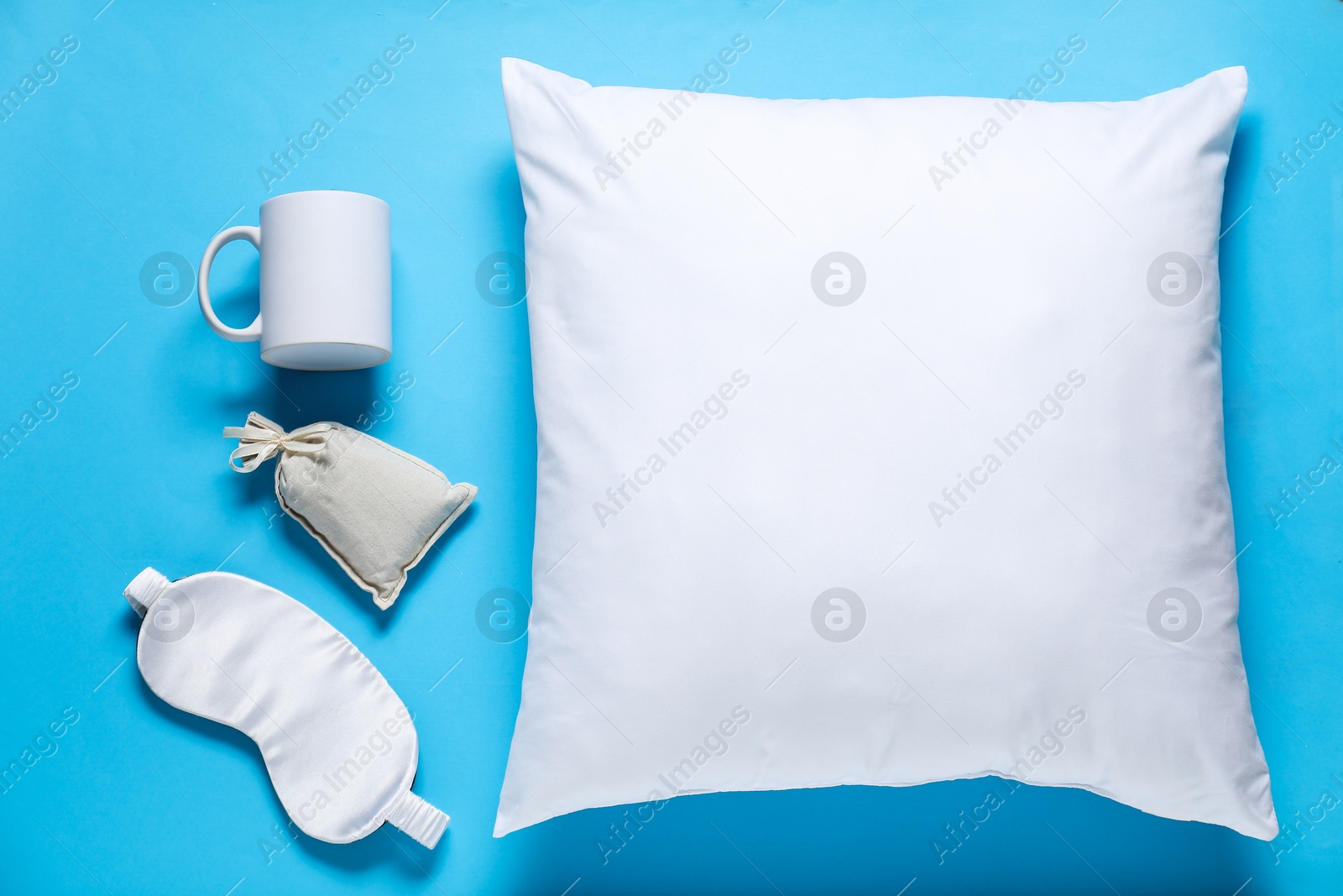 Photo of Different blank items for branding on light blue background, flat lay. Mockup for design