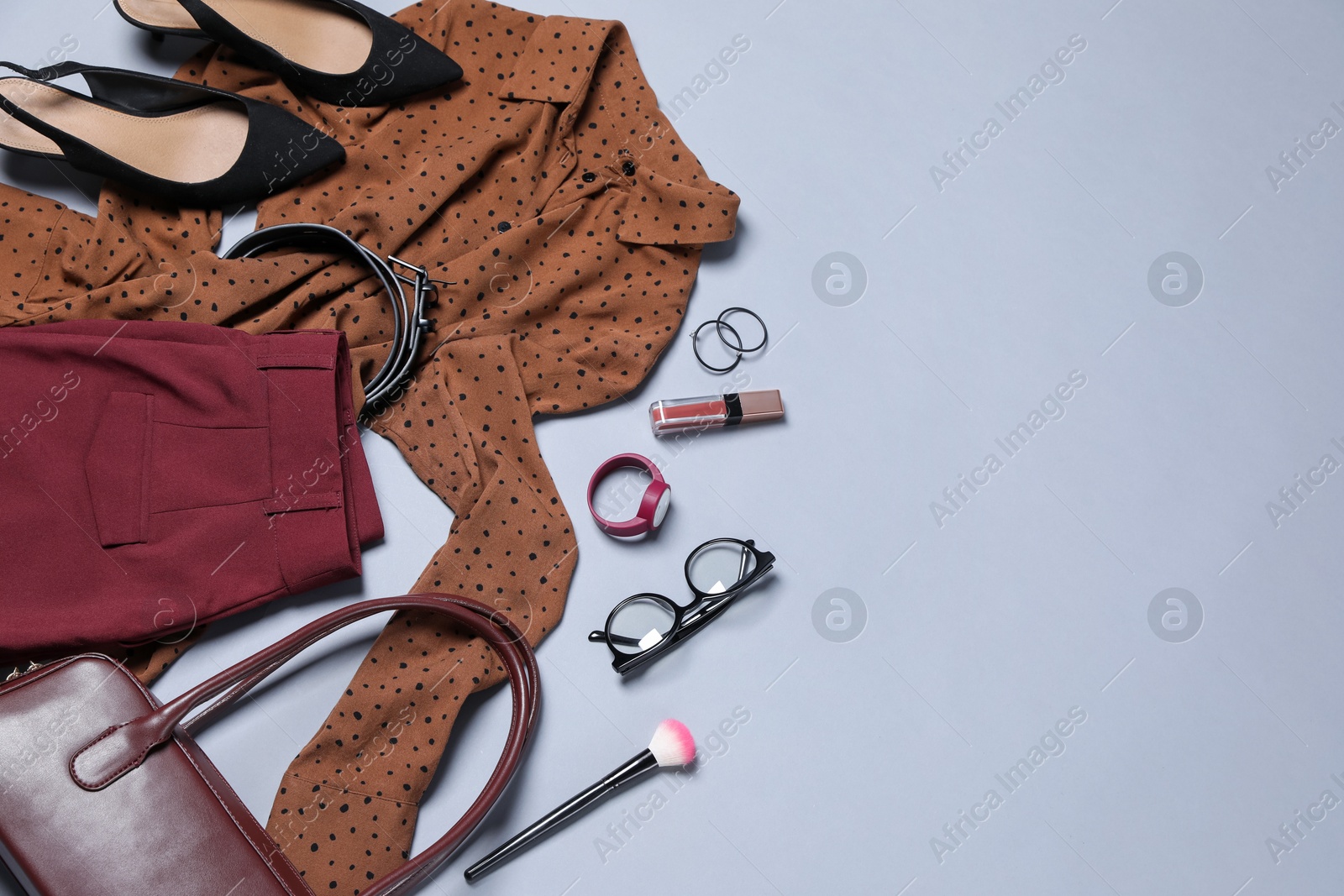 Elegant women's outfit. Stylish clothes and accessories on grey background, flat lay. Space for text Photo of Elegant women's outfit. Stylish clothes and accessories on grey background, flat lay. Space for text