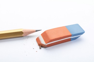 Eraser and pencil on white background, closeup