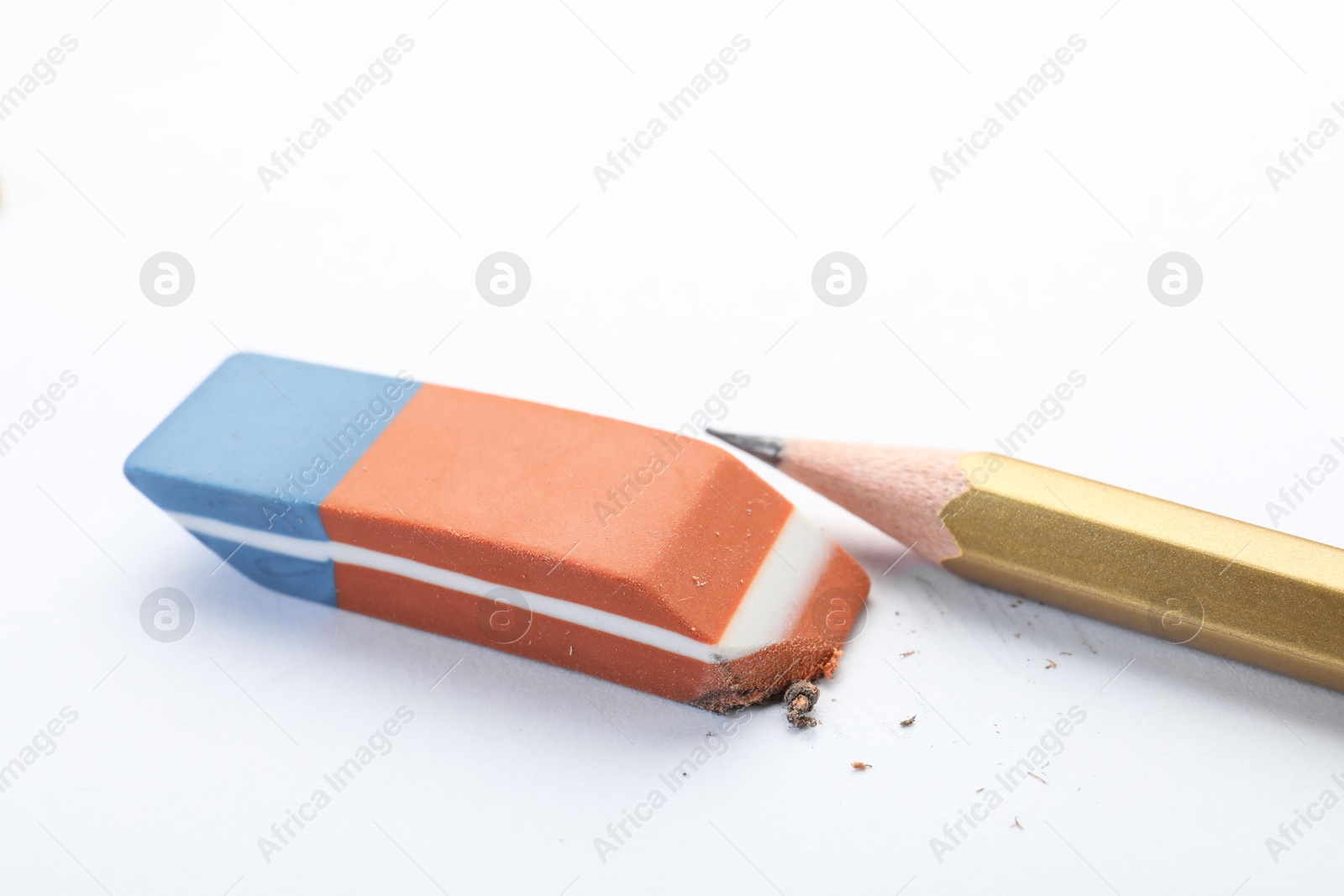 Photo of Eraser and pencil on white background, closeup