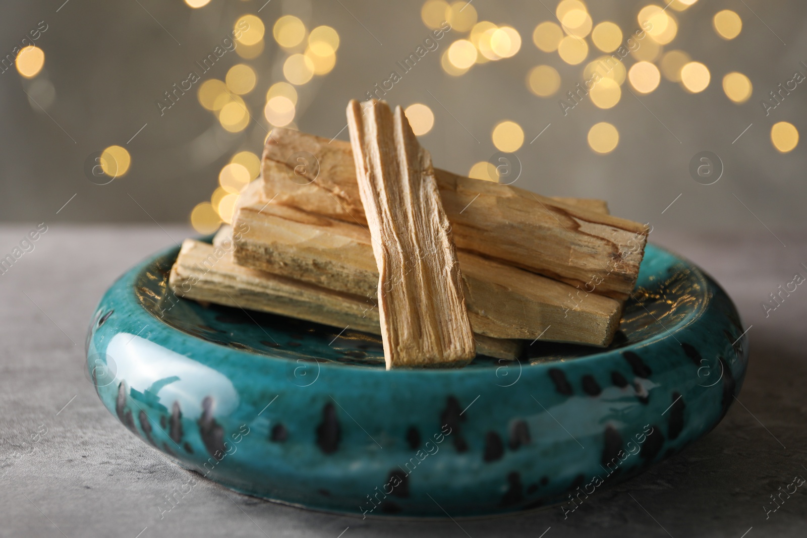 Palo santo sticks on grey table, closeup Photo of Palo santo sticks on grey table, closeup