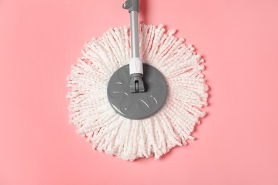 Photo of String mop on pink background, above view