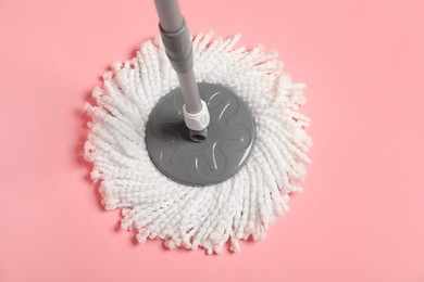 Photo of String mop on pink background, above view