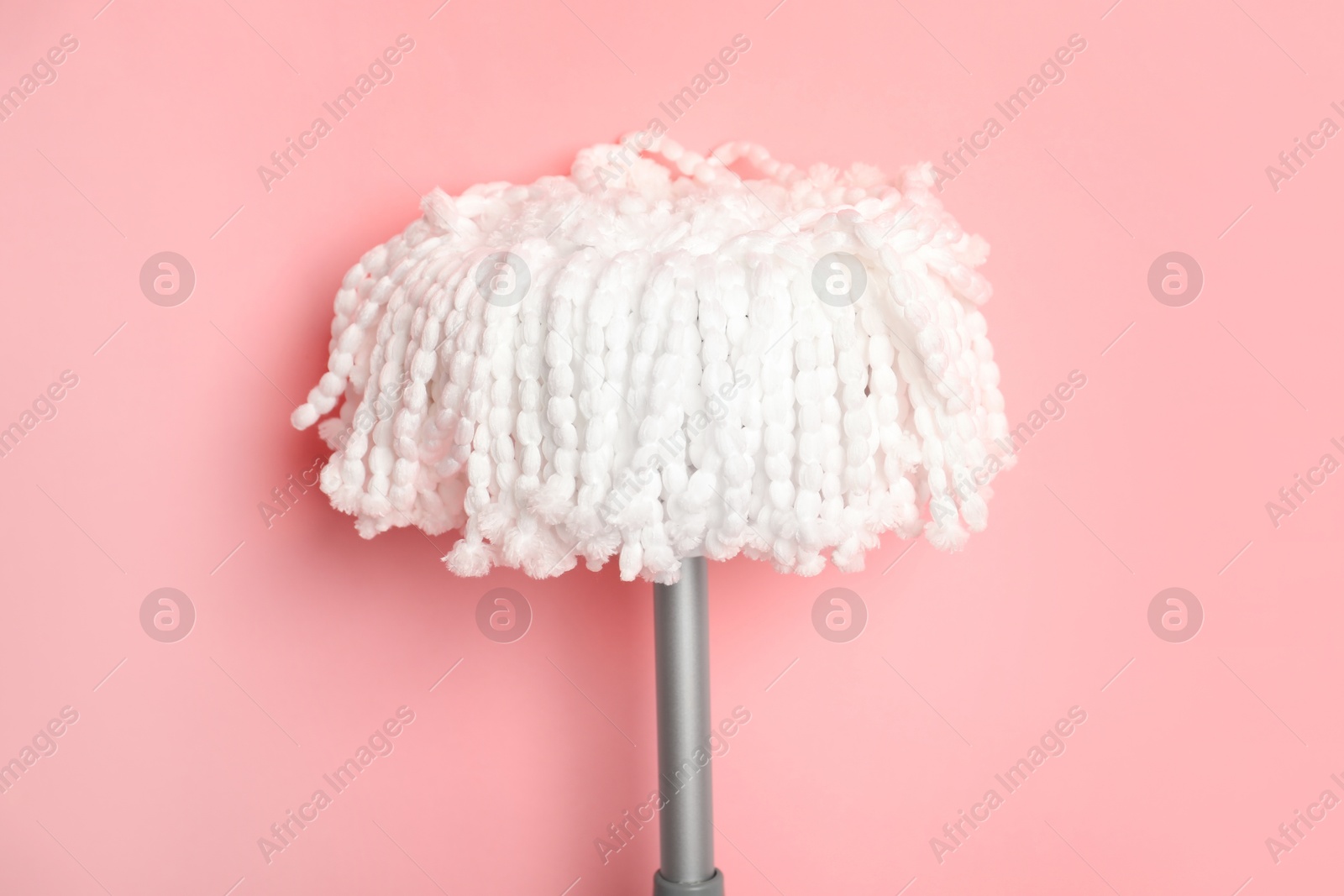 String mop on pink background. Cleaning equipment Photo of String mop on pink background. Cleaning equipment