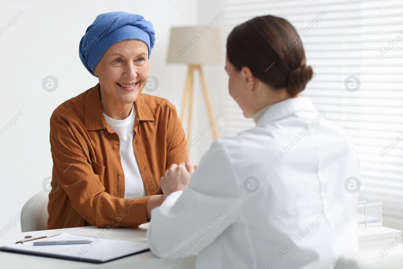 Photo of Senior woman with cancer visiting oncologist in clinic