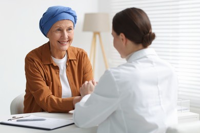 Photo of Senior woman with cancer visiting oncologist in clinic