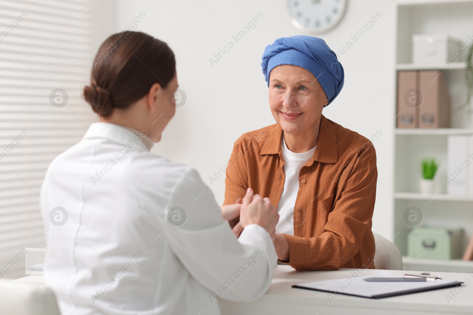 Photo of Senior woman with cancer visiting oncologist in clinic