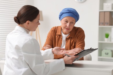 Photo of Senior woman with cancer visiting oncologist in clinic