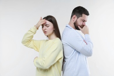 Photo of Resentful couple on light grey background. Relationship problem