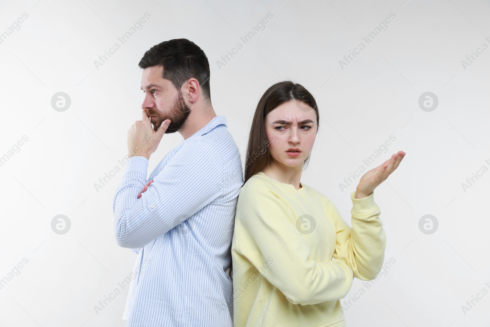 Photo of Resentful couple on light grey background. Relationship problem