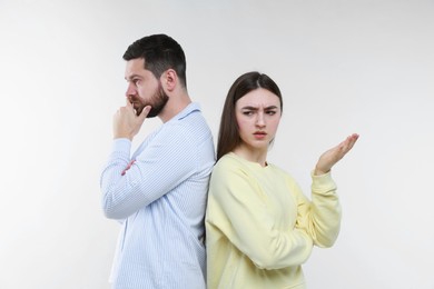 Photo of Resentful couple on light grey background. Relationship problem