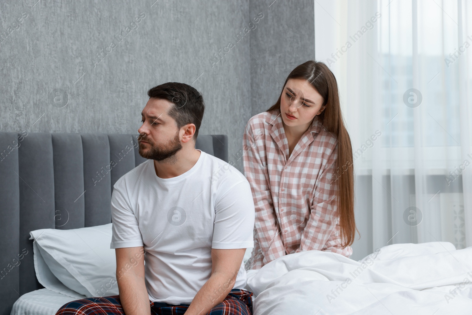 Photo of Resentful couple on bed at home. Relationship problem