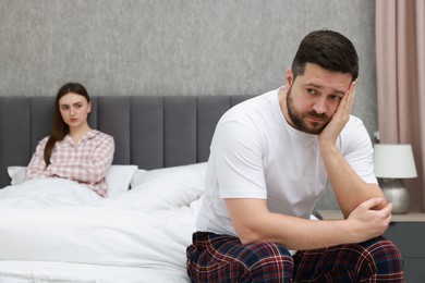 Photo of Resentful couple on bed at home, selective focus