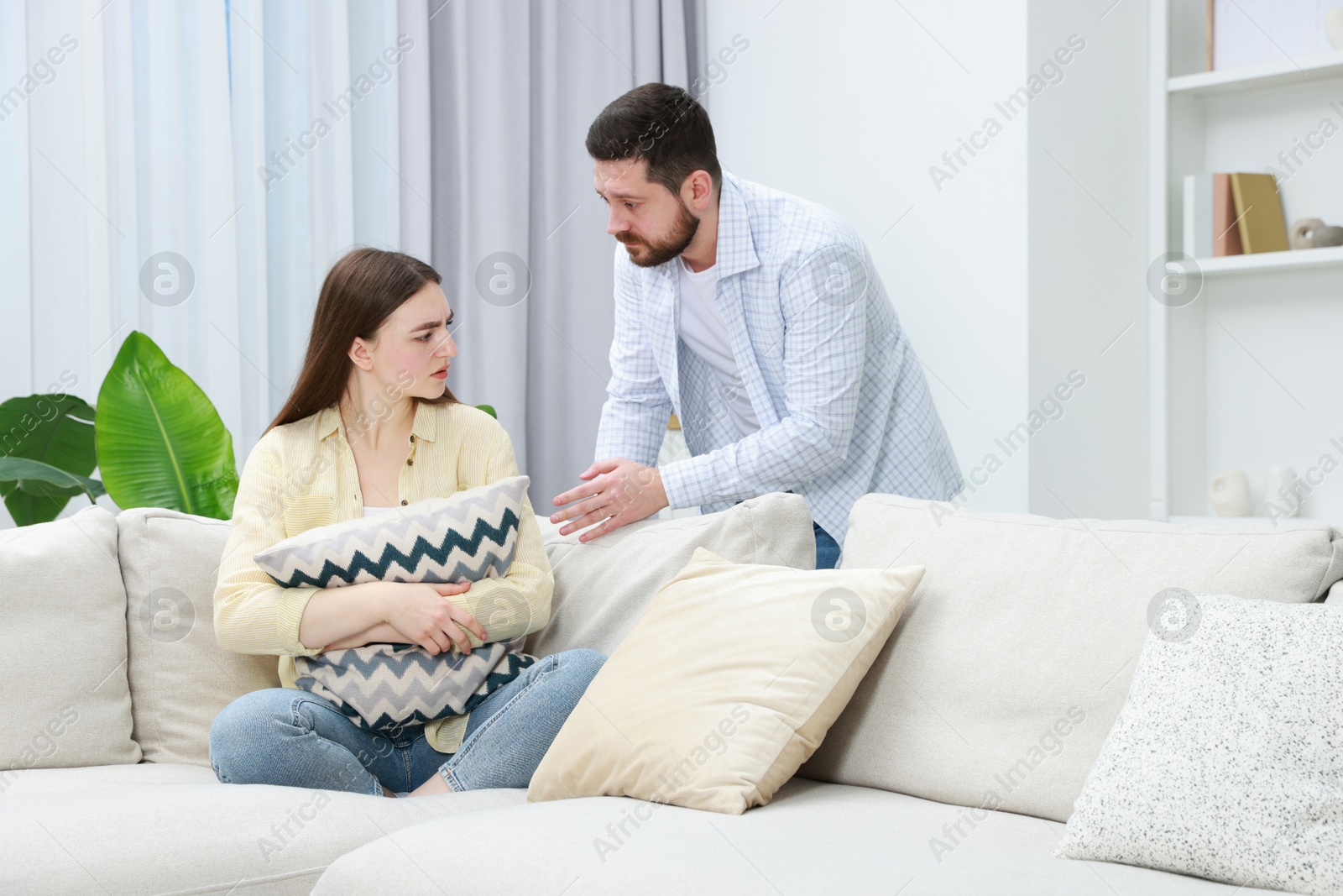 Photo of Man comforting his resentful girlfriend at home