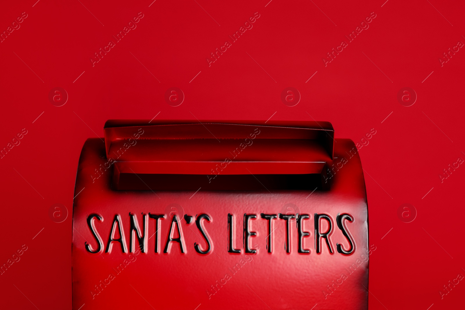 Photo of Santa Claus mailbox on red background, closeup. Christmas tradition