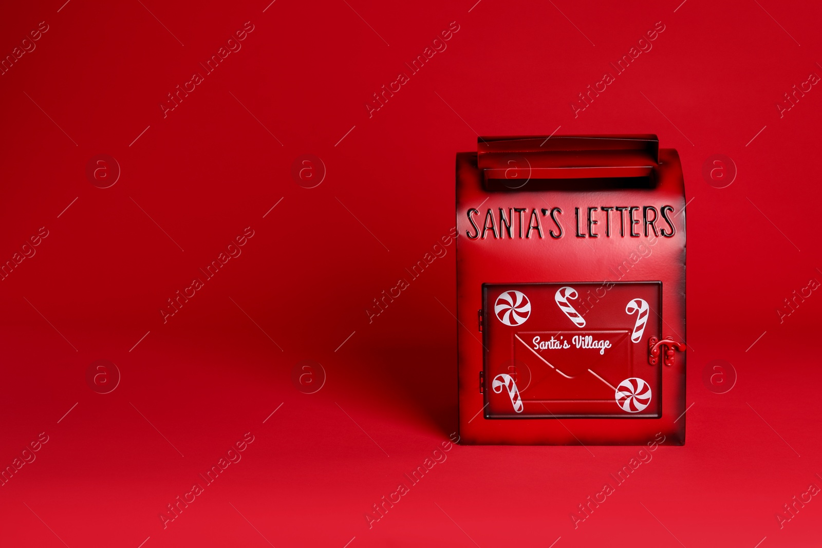 Photo of Santa Claus mailbox on red background, space for text. Christmas tradition