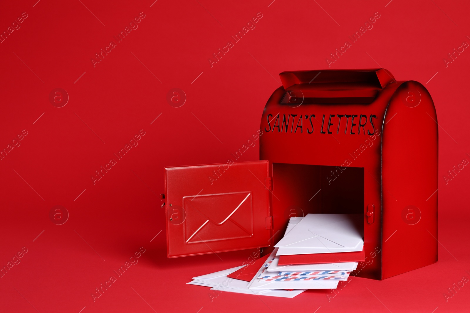 Photo of Open Santa Claus mailbox with letters on red background, space for text. Christmas tradition