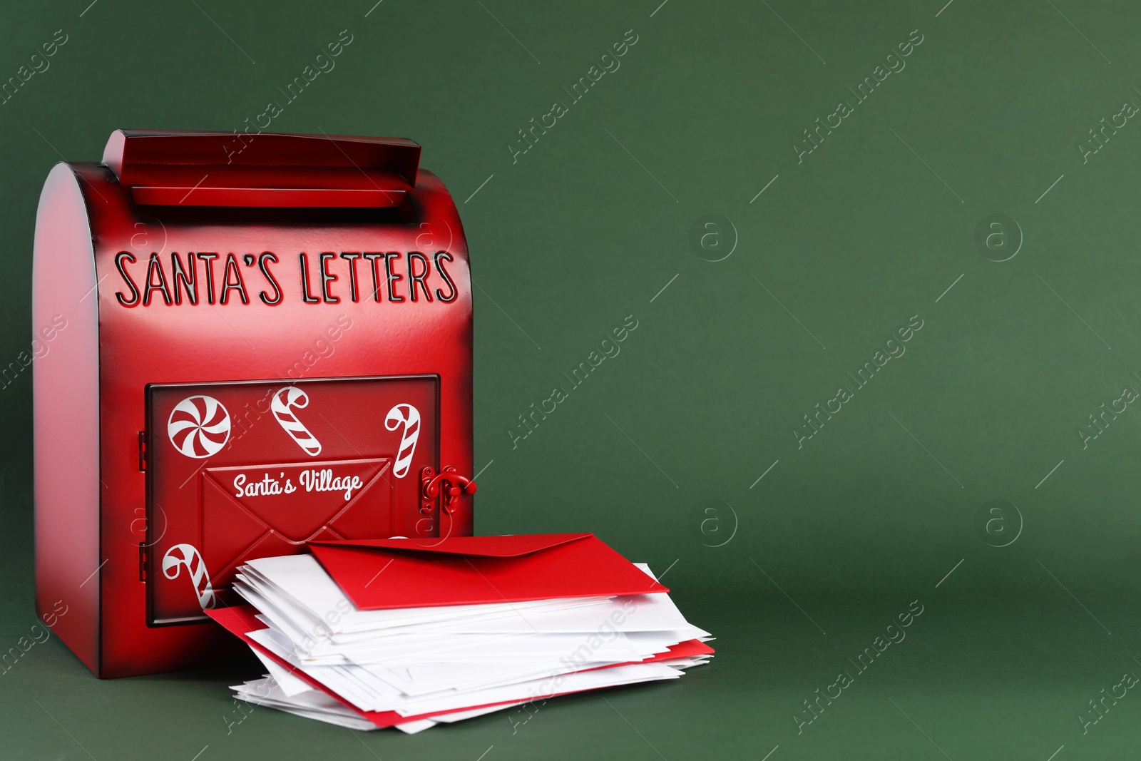 Photo of Santa Claus mail box with letters on dark green background, space for text. Christmas tradition