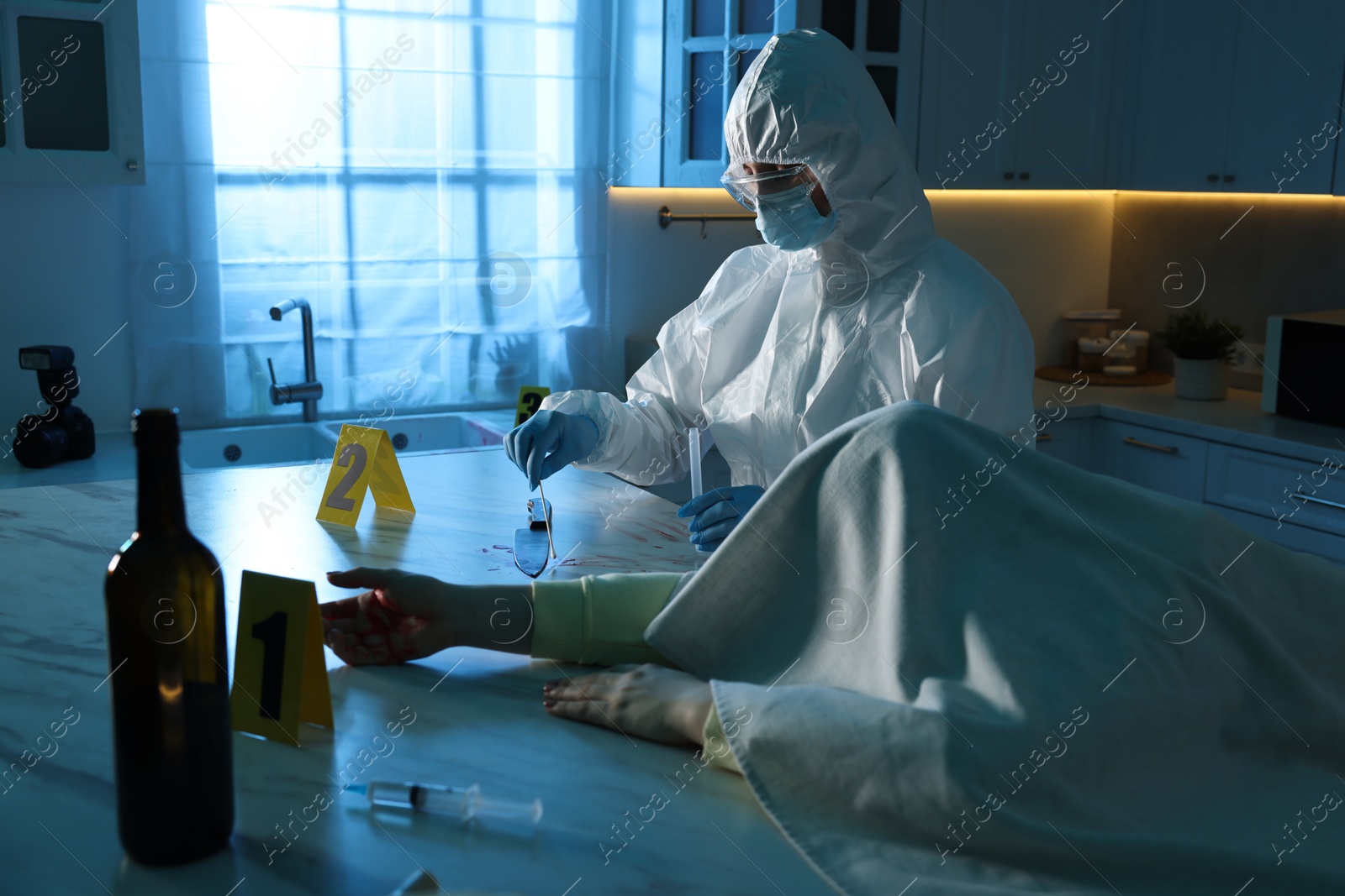 Photo of Forensic expert taking blood sample and dead woman's body at countertop indoors