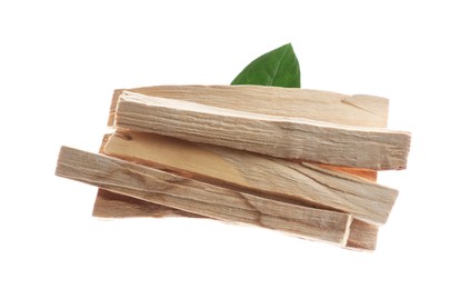 Photo of Palo santo sticks and green leaf on white background