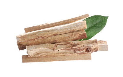 Photo of Palo santo sticks and green leaves on white background