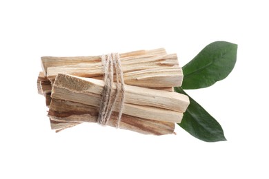 Photo of Palo santo sticks and green leaves on white background