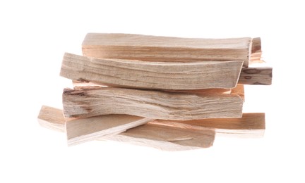 Photo of Pile of palo santo sticks on white background