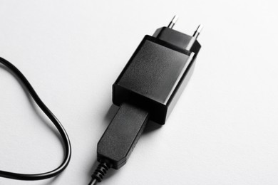 Photo of USB power adapter with charge cable on white background, closeup