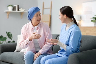 Photo of Woman with cancer and nurse at home