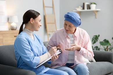 Woman with cancer and nurse at home