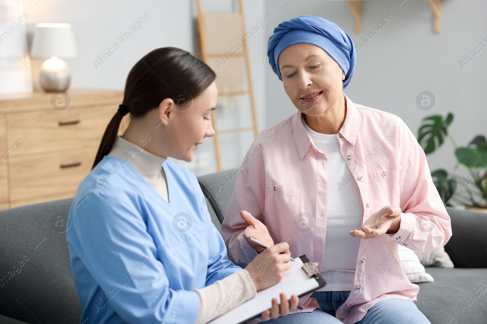 Photo of Woman with cancer and nurse at home