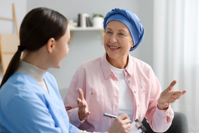 Photo of Woman with cancer and nurse at home