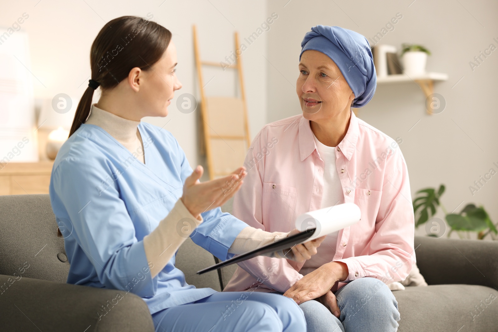 Photo of Woman with cancer and nurse at home