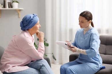 Photo of Woman with cancer and nurse at home