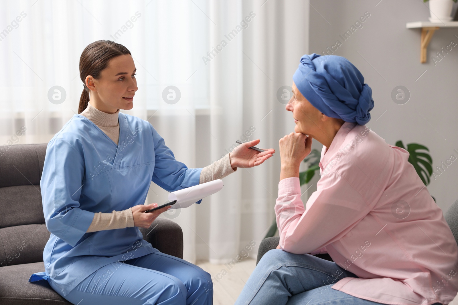 Photo of Woman with cancer and nurse at home