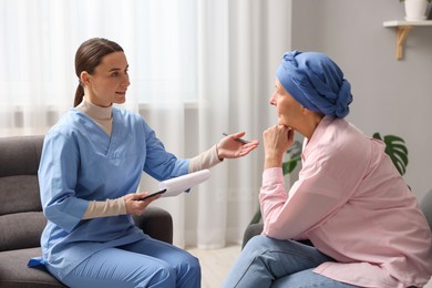 Woman with cancer and nurse at home